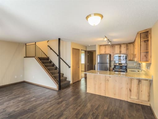 a living room with a kitchen and a staircase at Campus Park, Duluth, MN, 55811