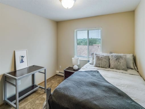 a bedroom with a bed and a desk and a window at Campus Park, Duluth, 55811