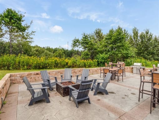 a patio with chairs and tables and a fire pit  at Campus Park, Duluth