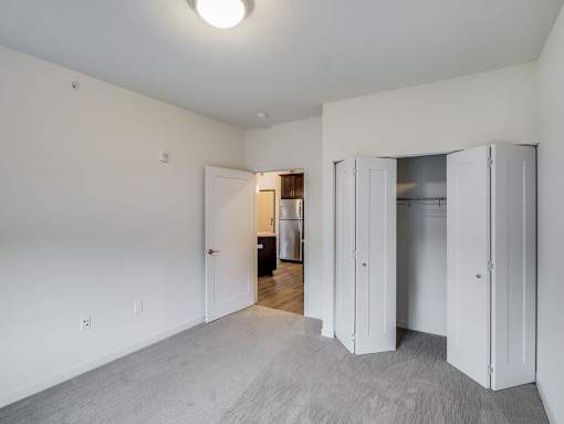 a bedroom with white walls and a closet at Arbor Ridge, Minnesota, 55025