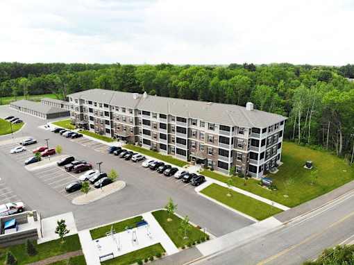 an aerial view of a large apartment building in a parking lot at Arbor Ridge, Forest Lake, MN, 55025