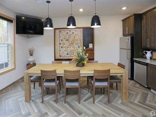 a dining room with a wooden table and chairs at Arbor Ridge, Forest Lake, MN