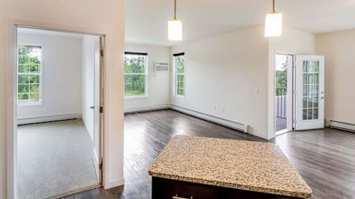 an empty living room with a table in the middle at Arbor Ridge, Forest Lake, MN