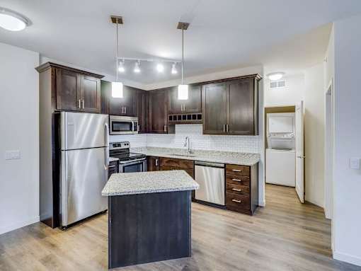a kitchen with stainless steel appliances and a marble counter top at Arbor Ridge, Forest Lake, 55025