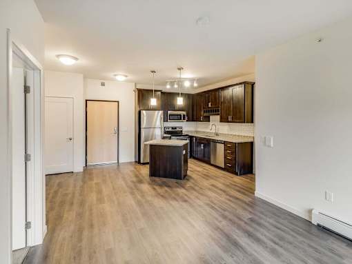 a kitchen with a stove and a refrigerator at Arbor Ridge, Forest Lake, 55025