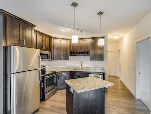 a kitchen with stainless steel appliances and wooden cabinets at Arbor Ridge, Forest Lake, MN, 55025