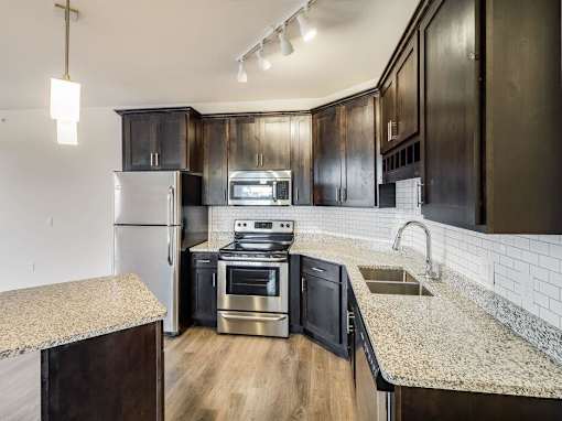 a kitchen with stainless steel appliances and granite counter tops at Arbor Ridge, Forest Lake, Minnesota