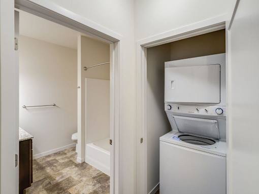 a washer and dryer in a laundry room with a door to a bathroom at Arbor Ridge, Forest Lake, 55025
