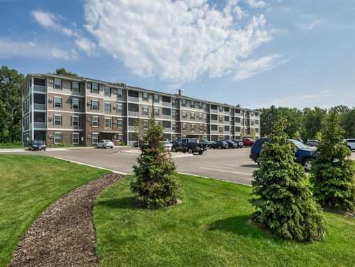 an apartment building on the corner of a parking lot at Arbor Ridge, Forest Lake, 55025