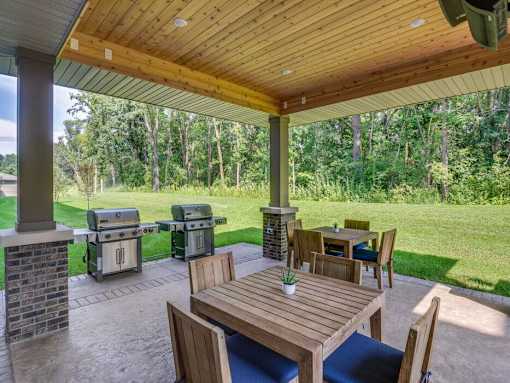 a covered patio with tables and barbecue grill at Arbor Ridge, Forest Lake, MN, 55025