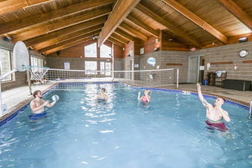 a group of people in a swimming pool playing with a frisbee at Campus Park, Duluth, 55811