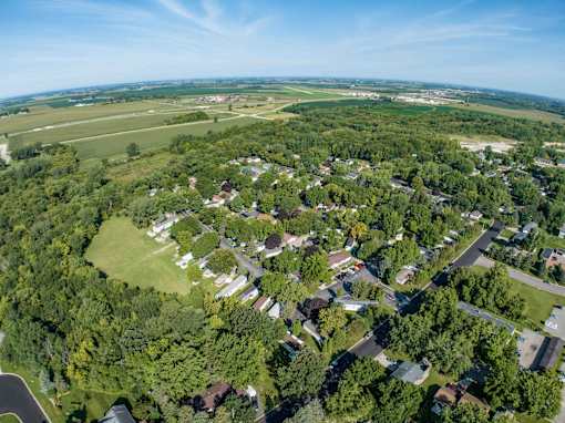 a aerial view of a neighborhood of houses and trees and a field