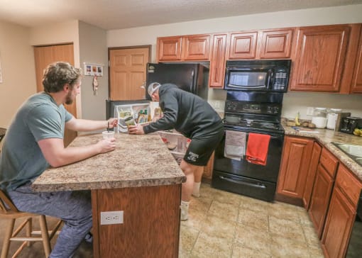 two men working on the counter in a kitchen at Summit Ridge, Duluth, Minnesota