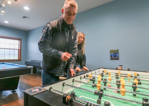 two people playing a game of foosball at a table at Summit Ridge, Duluth, MN