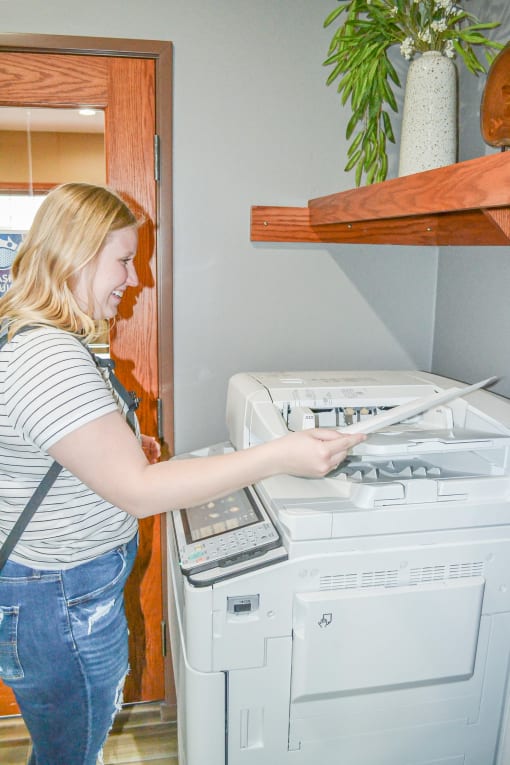a woman is using a calculator on a washing machine at Summit Ridge, Minnesota
