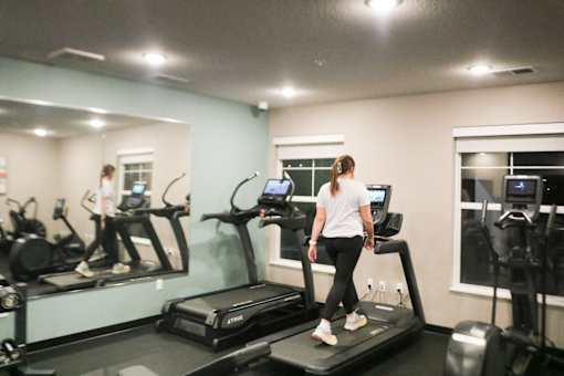 a woman running on a treadmill in a gym  at Timber Ridge, Forest Lake, MN, 55025