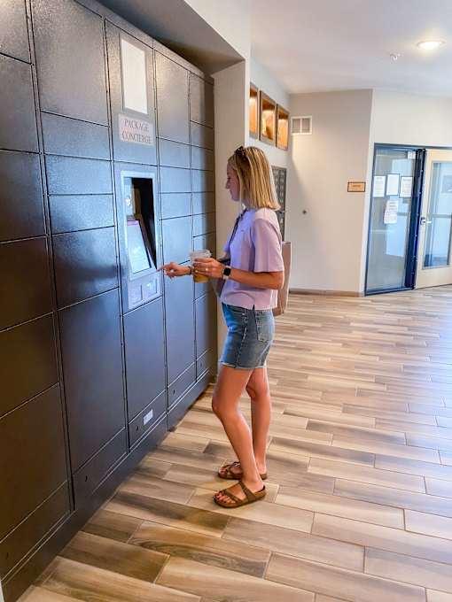 a woman picking up her package in the lobby  at Timber Ridge, Forest Lake