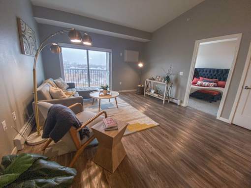 a living room with a couch and a chair and a floor lamp  at Timber Ridge, Forest Lake, 55025