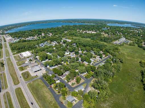 an aerial view of a city with a lake in the background