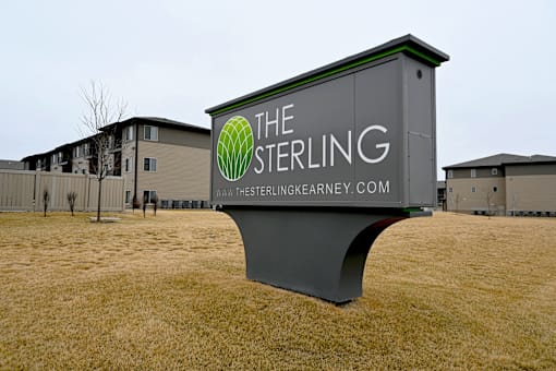 A sign for The Sterling Kearney company is displayed in a field.