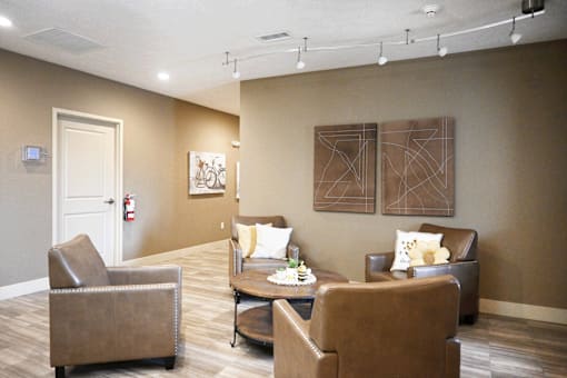 A waiting room with brown chairs and a fire extinguisher on the wall.