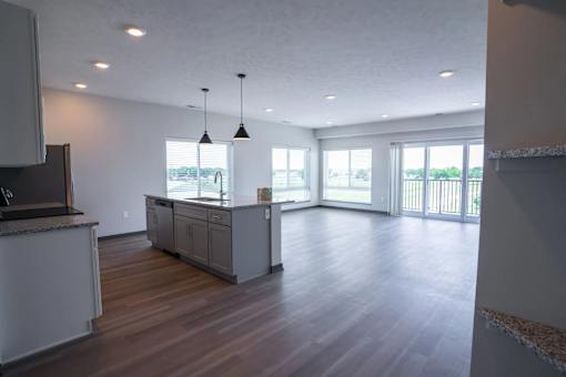 A kitchen with a wooden floor and a large island in the middle.