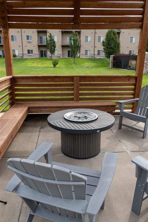 A patio with a table and chairs.