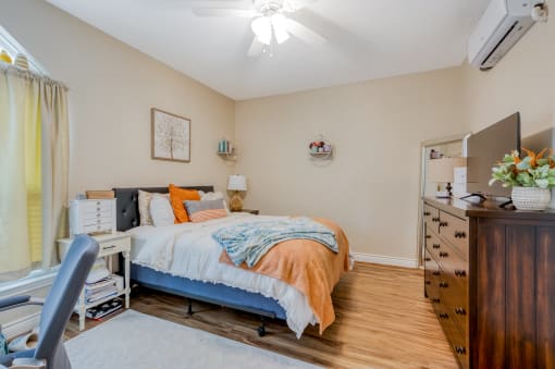 a bedroom with a bed and a dresser