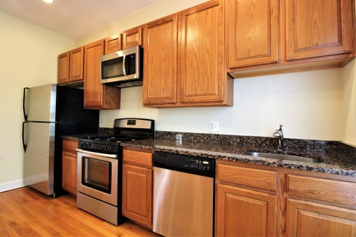 a kitchen with stainless steel appliances and wooden cabinets