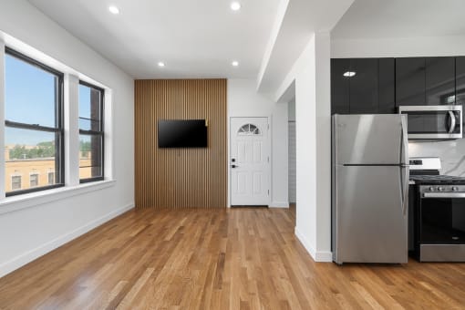 a kitchen with a refrigerator and a stove and a door
