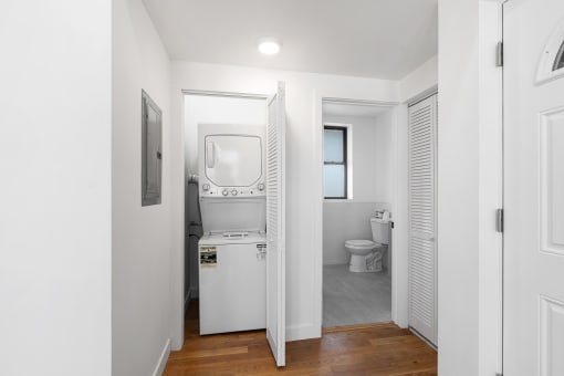 a small bathroom with a washer and dryer in it