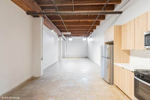 A spacious kitchen with wooden cabinets and stainless steel appliances.