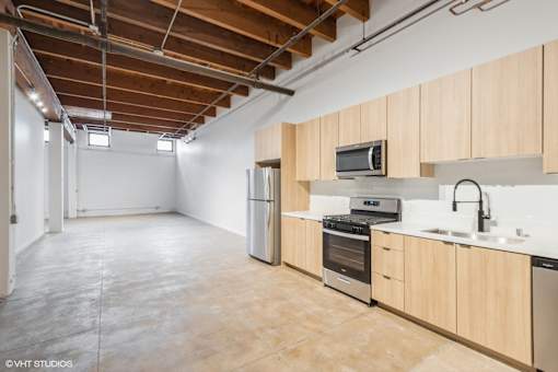 A kitchen with wooden cabinets and stainless steel appliances.