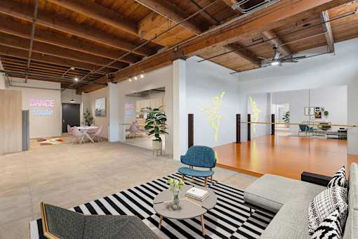 A dance studio is located in the back of this open plan office space.