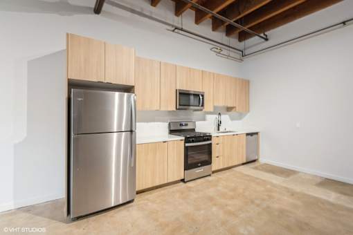 A kitchen with wooden cabinets and stainless steel appliances.