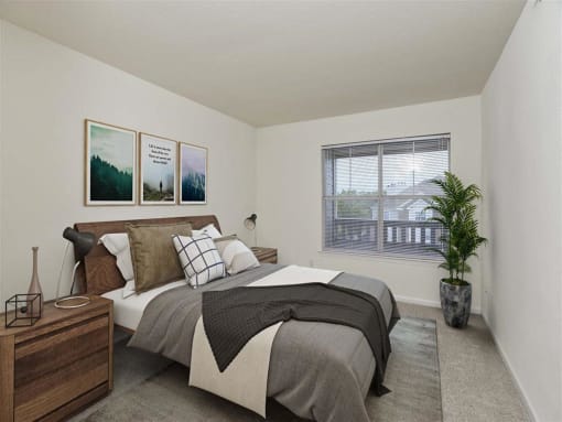 Minimalist bedroom with a wooden bed frame, stylish decor, and a large window offering natural light and balcony views.