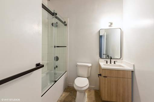A white toilet sits next to a sink in a small bathroom.