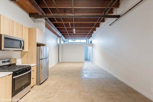 A kitchen with wooden cabinets and stainless steel appliances.