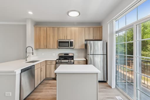 Davey Two Bedroom Townhome - renovated kitchen with stainless steel appliances and rich wood cabinetry
