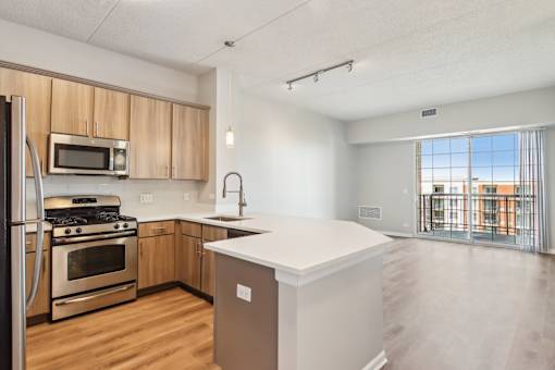 A kitchen with a refrigerator, oven, and microwave.