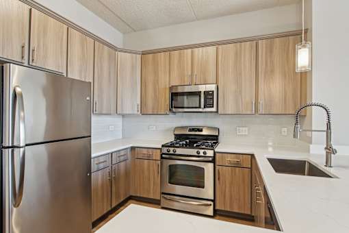 A kitchen with wooden cabinets and stainless steel appliances.