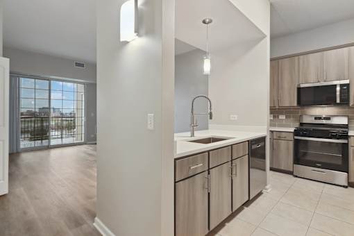 A kitchen with a sink, stove, and oven.
