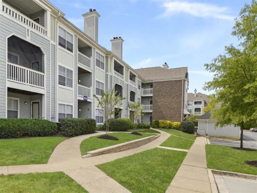 Apartment complex with a walkway between the buildings.