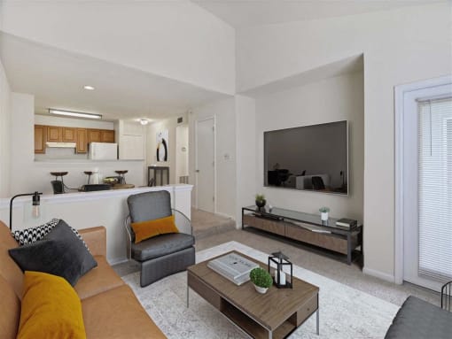 A modern living room with a brown sofa and a grey armchair.
