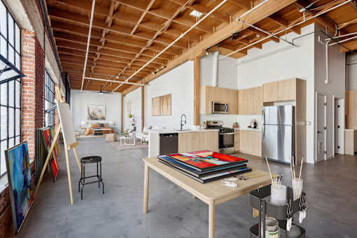 A room with a wooden ceiling and a table with a book on it.