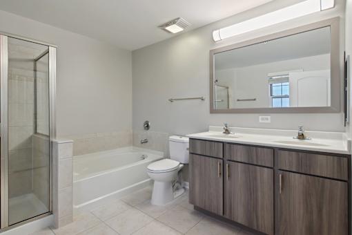 A bathroom with a toilet, sink, and shower.