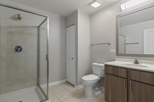 A bathroom with a toilet, sink, and shower.