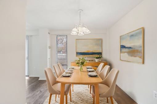 A dining room with a wooden table and chairs.