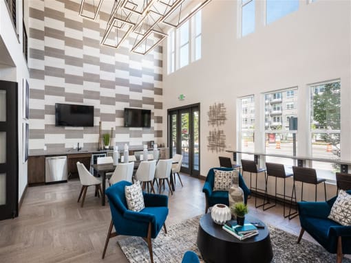 a lounge area with chairs and tables and a television