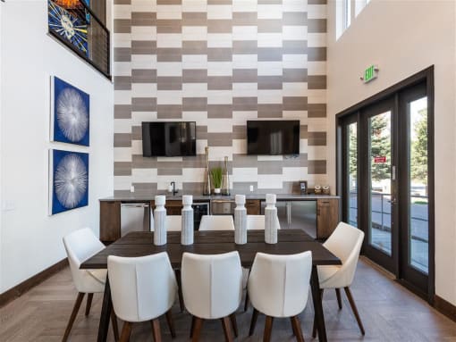 a dining room with a table and chairs